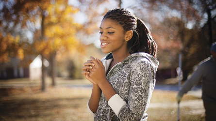 A young woman amidst trees in autumn seeking the Spirit